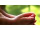 A person calmly practicing deep breathing in a tranquil setting, symbolizing stress relief