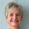 Photo of Margaret S., a smiling woman in her late 50s, looking vibrant and healthy.